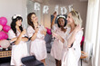 © Wavebreak Media - Diverse female friends in robes celebrating bridal shower with champagne and makeup, at home
