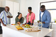 © Wavebreak Media - Family enjoying conversation and preparing meal together in modern kitchen