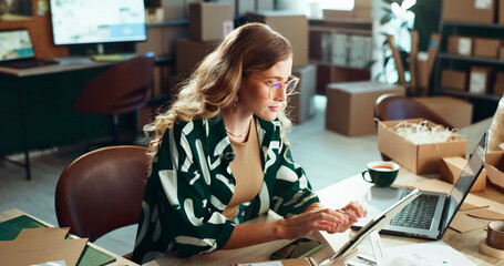 Leinwandbilder - Logistics, online order and tablet with woman in office for delivery or shipping schedule. Laptop, planning and supply chain with courier person at desk in depot or warehouse for ecommerce tracking