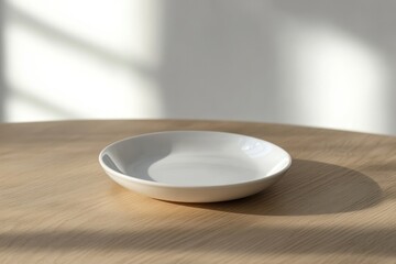 Poster - Minimalist white plate on wooden table with soft shadows