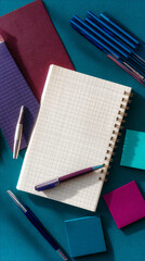 Fototapete - Flatlay showcasing notebook, pens, sticky notes on teal background Mockup for business, education, or stationery branding Free space for text or logo