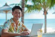 © Ekaterina Chemakina - Happy Asian man freelancer is working on a laptop on an ocean beach. Palm tree and ocean on the background.