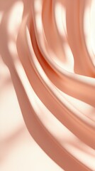 Poster - Soft peach silk fabric drapes elegantly creating luxurious flowing folds and textures illuminated by gentle sunlight casting delicate shadows.