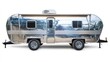 © Almahyra - Polished silver travel trailer on white background.