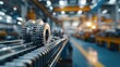 © JT Studio - A close-up view of gears on a conveyor system in a factory, highlighting industrial machinery and production processes.