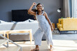 © Wavebreak Media - Young girl dancing joyfully at home wearing headphones, enjoying music