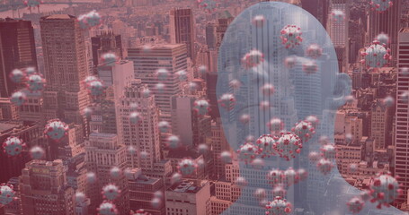 Poster - Image of covid 19 cells floating over human head and cityscape on red background