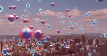 Poster - Image of covid 19 cells floating over cityscape on pink background