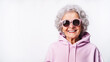 © Irina - Portrait of cheerful elderly woman in pink sweatshirt and sunglasses on white background with copy space. Fashionable granny in glasses