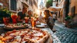 © Olga B.G. - Friends happily dining on pizza and drinks outdoors against a sunlit European street at sunset