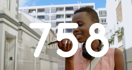 Poster - Image of numbers changing over woman talking on smartphone