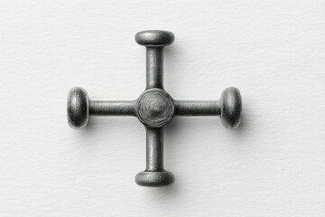Poster - Unique metal cross-shaped object resting on a textured surface showcasing intricate design and craftsmanship