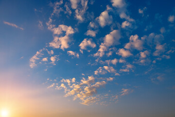 Wall Mural - sunset with bright sun, blue sky and pink clouds