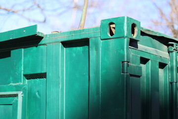 Poster - A detailed view of a green trash can with a lid and a handle, suitable for use in illustrations about recycling or waste management.