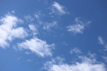 Poster - White clouds in a blue bright sky.