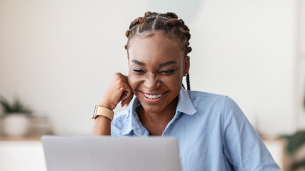 Poster - Good Working Day. Smiling Black Female Employee Using Laptop And Drinking Coffee At Workplace In Modern Office, Checking Emails, Free Space