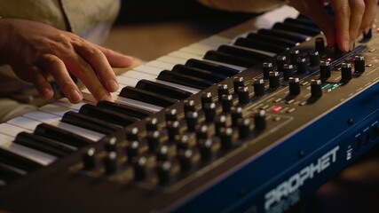 Leinwandbilder - Skilled musician performing in control room at studio and recording tracks for new album, working with audio console and flying faders. Songwriter composing new music on technical tools. Camera A.