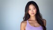 © sukarman - A glamorous, studio portrait of a asian woman with long, dark, wavy hair, wearing a light purple lavender tank top