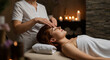 © Tahira - Tranquil escape A woman receives a soothing facial massage in a serene spa setting, bathed in soft candlelight.