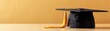 © Chanoknan - Elegant black graduation cap with golden tassel on wooden table against warm yellow background