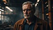 © JuliaM - Older man looks serious. Brown jacket. Industrial area visible. Pipes and metal structure behind him. Lights hang overhead in background.