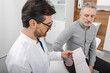 © Peakstock - Doctor cardiologist consulting senior man patient on results of his cardiogram and heart test. Diagnostic heart diseases, cardiology