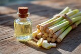 Lemongrass oil bottle and stalks on rustic wood table, natural remedy