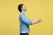 © Maria Vitkovska - Man showing or receiving something with open hands on yellow background