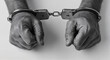 © Margarita - Hands in Handcuffs Displaying Restriction Against a White Background