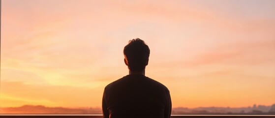 Wall Mural - Man looks at sunset