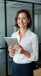 © STM Lab - Confident Businesswoman Using Tablet in Modern Office