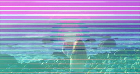 Poster - Person sitting on rocky beach with colorful striped animation overlay