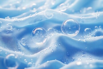 Poster - Water droplets cling to soft blue fabric, capturing light and enhancing the fabric's texture in a tranquil, serene moment