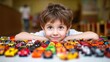 © Nataliya - A cheerful boy surrounded by a colorful collection of toy cars