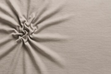 Poster - Soft, beige fabric twisted into a spiral shape, creating a stunning, textured background. Offering ample space for text or design, this elegant material enhances any project