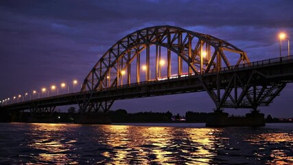 Aufkleber - Beautifully illuminated bridge over calm waters at dusk showcasing architectural elegance