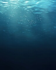 Poster - Underwater scene with sunlight piercing through the water surface creating a serene and peaceful atmosphere in the deep blue sea