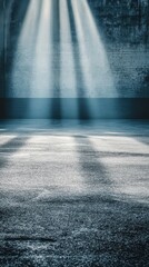 Poster - Dramatic light beams illuminate a textured brick wall and concrete floor creating a moody and atmospheric scene with a sense of depth and mystery