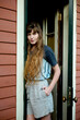 © Connect Images - Woman with long hair standing in a doorway, wearing casual summer clothing. New Orleans, Louisiana, USA