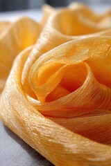 Poster - Abstract close up of golden silk fabric creating a flowing texture and pattern with soft light and shallow depth of field for a luxurious feel