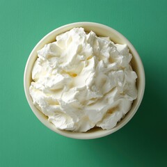 Poster - Creamy delight in a bowl against a vibrant green backdrop showcasing smooth texture and culinary appeal perfect for dessert toppings