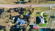 © Austockphoto - Two houses on the outskirts of a town one neat and tidy the other messy and a paddock