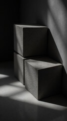Poster - Minimalist concrete cubes create striking contrast with shadows and light, showcasing modern design and texture in serene setting