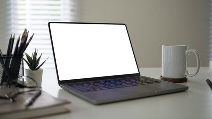 Aufkleber - Modern desk setup featuring a laptop with a blank white screen, perfect for customization.