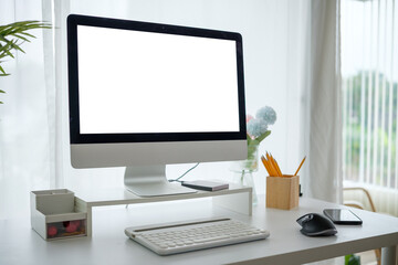 Aufkleber - Desktop computer with a blank white screen and stationery on desk in modern office.