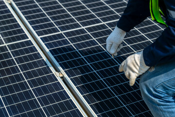Wall Mural - two engineers install solar panels on a rooftop, wearing safety gear and helmets. the scene showcase