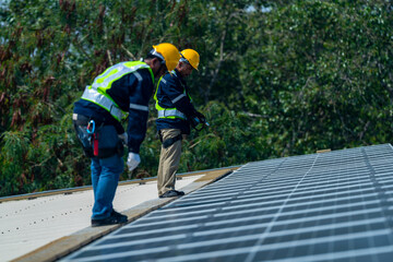 Wall Mural - team of professionals installs solar panels, ensuring energy efficiency and sustainable development.