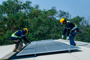 Wall Mural - two engineers install solar panels on a rooftop, wearing safety gear and helmets. the scene showcase