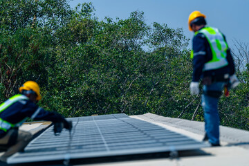 Wall Mural - two engineers install solar panels on a rooftop, wearing safety gear and helmets. the scene showcase