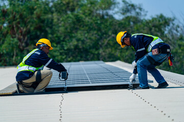 Wall Mural - two engineers install solar panels on a rooftop, wearing safety gear and helmets. the scene showcase